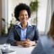 Two diverse businesswomen talking working together in office