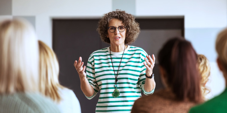 A woman speaks during a seminar.